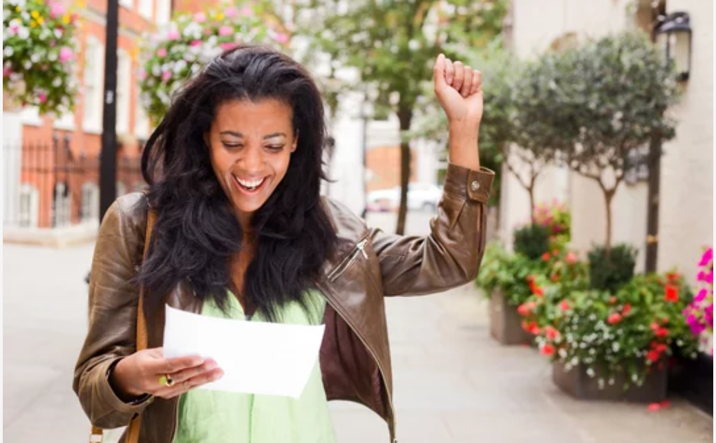 woman reading letter smiling