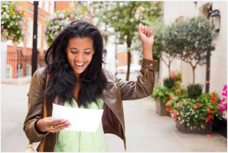 woman reading letter smiling