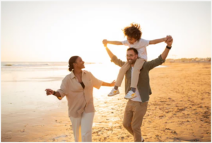 Happy family walking on the beach