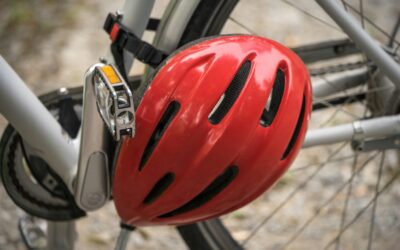 bike-helmet Red bicycle helmet hanging on a bike, representing safety and protection against head injuries from defective products.