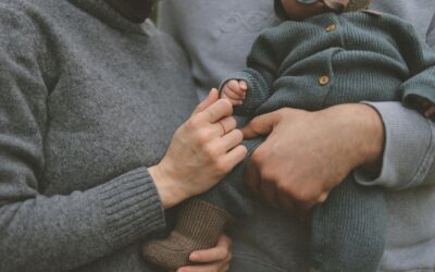 Img - Financial Resources and Legal Support for Your Child After a Traumatic Brain Injury Parents holding a baby’s hand