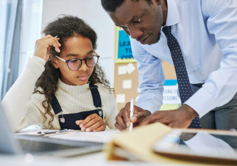 Child works with teacher on classwork