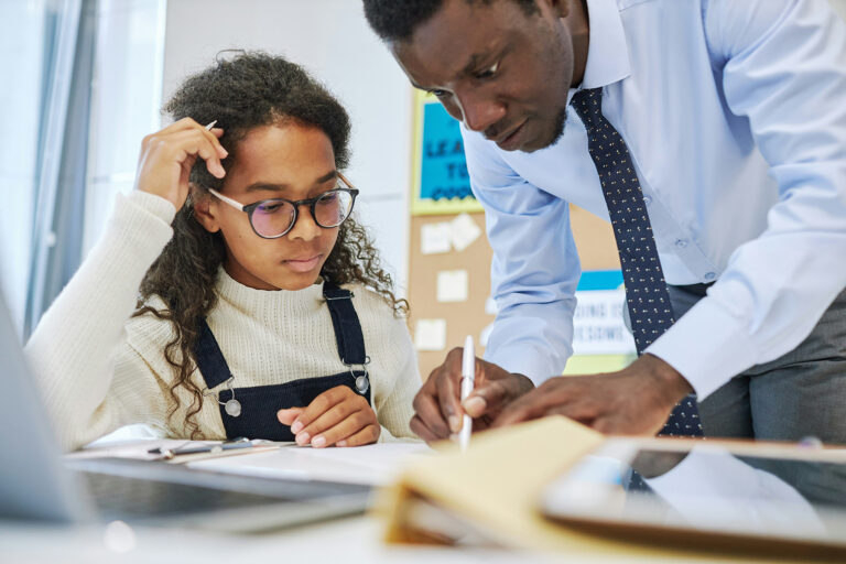 Child works with teacher on classwork