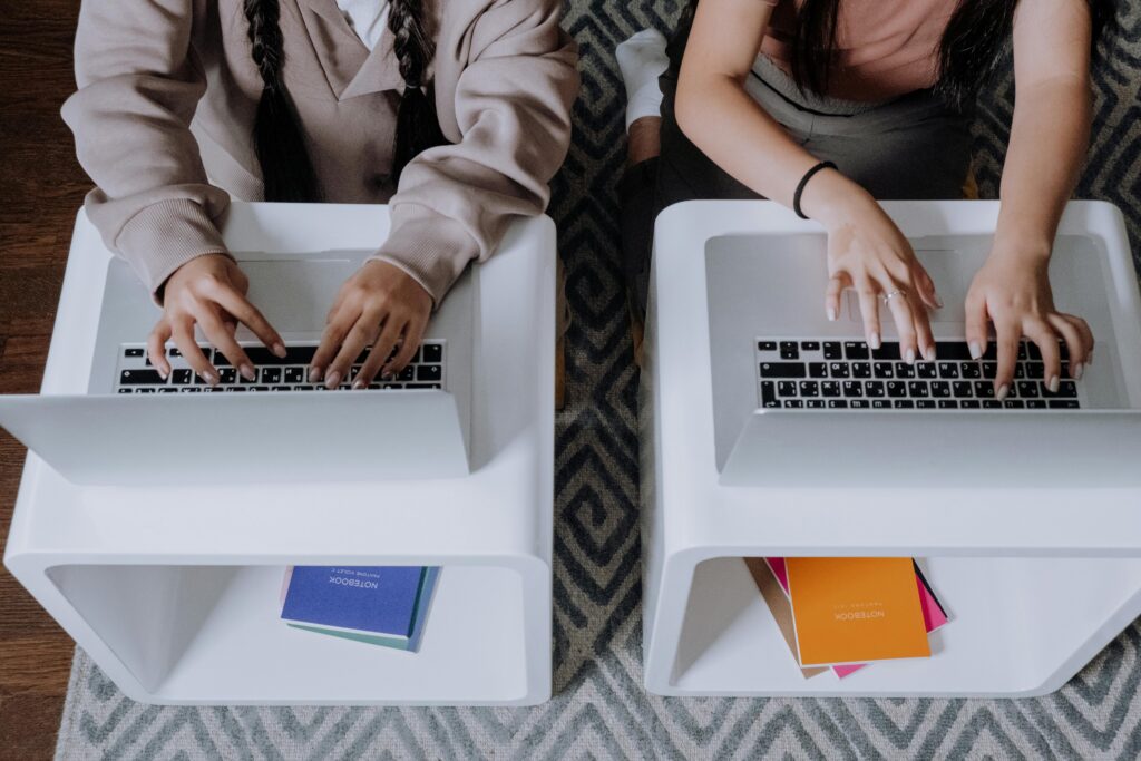 Two students use laptops