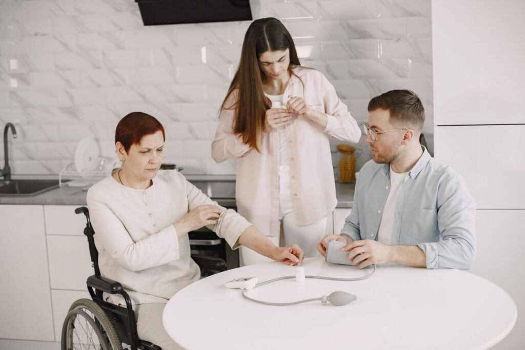 Caregiver helping a family member in a wheelchair at home, representing Medicaid home and community-based care after a TBI